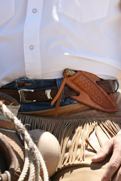 Cross draw knife in decorative leather sheath attached to a western belt with fringe chaps on Tampa Home & Garden Store