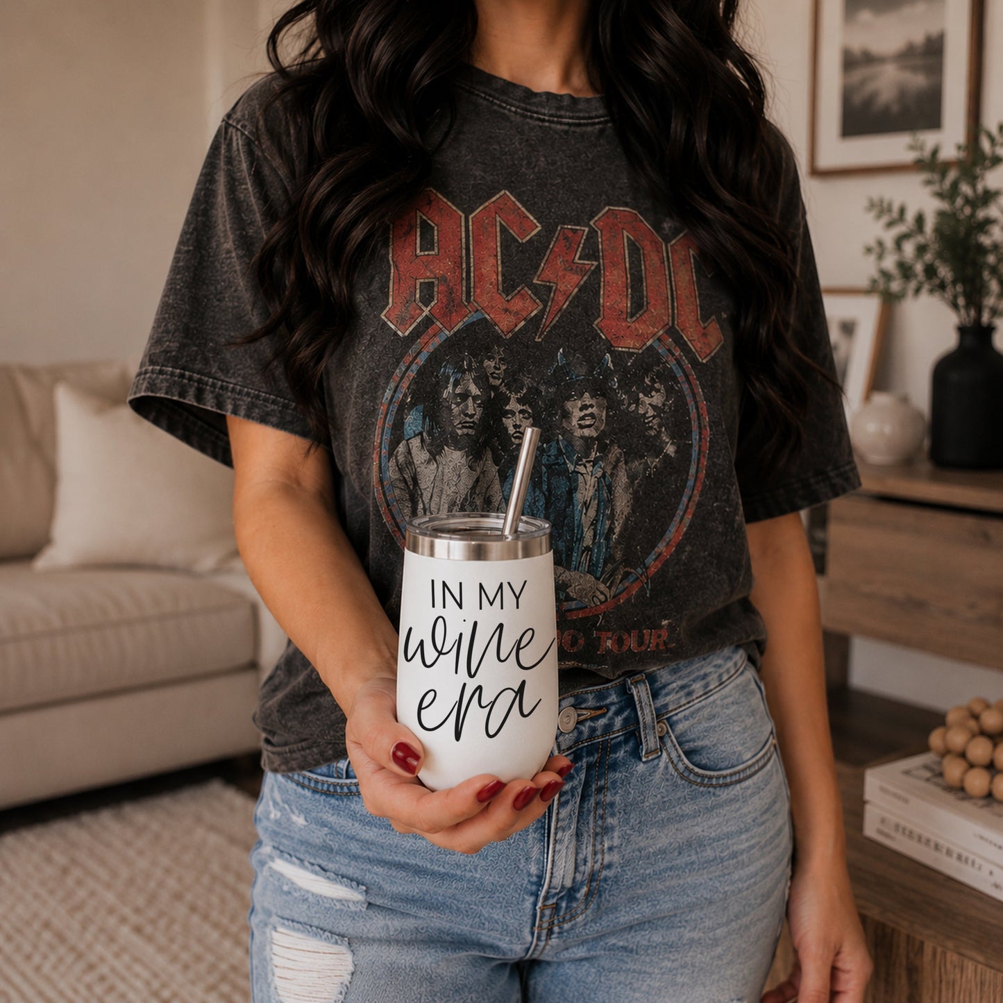 Wine Era 17oz tumbler with stainless steel lid and straw, held by person in band tee on Tampa Home & Garden Store