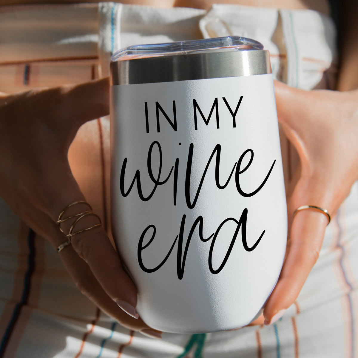 Wine Era 17oz tumbler, white with clear lid, bold black script held by hands on Tampa Home & Garden Store