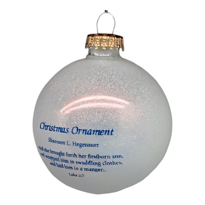 Mother and Child Nativity Glass Ball Ornament, frosted gray with blue text and gold cap on Tampa Home & Garden Store