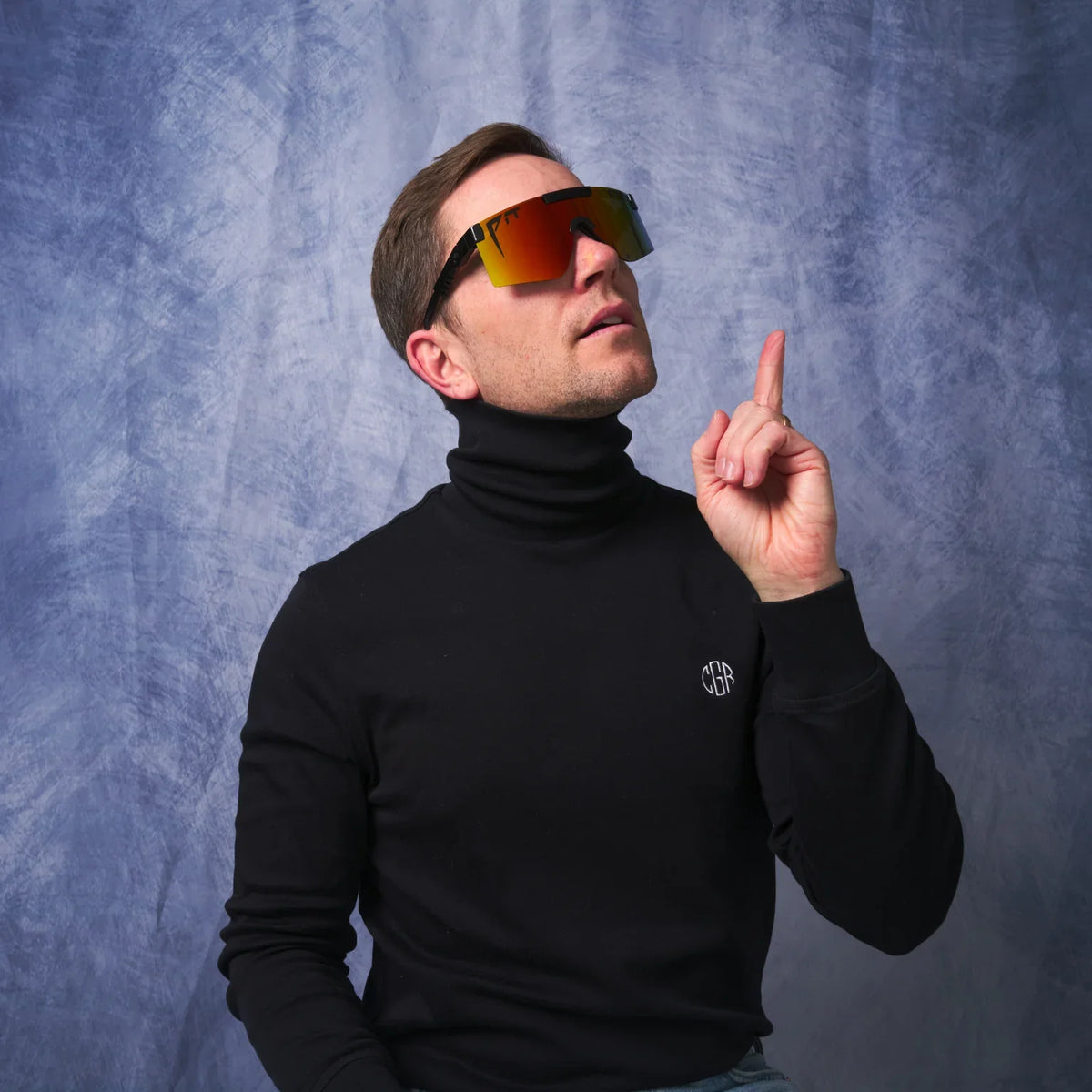 Pit Viper UV400 sunglasses with orange mirrored lenses and black frame worn by a man on Tampa Home & Garden Store