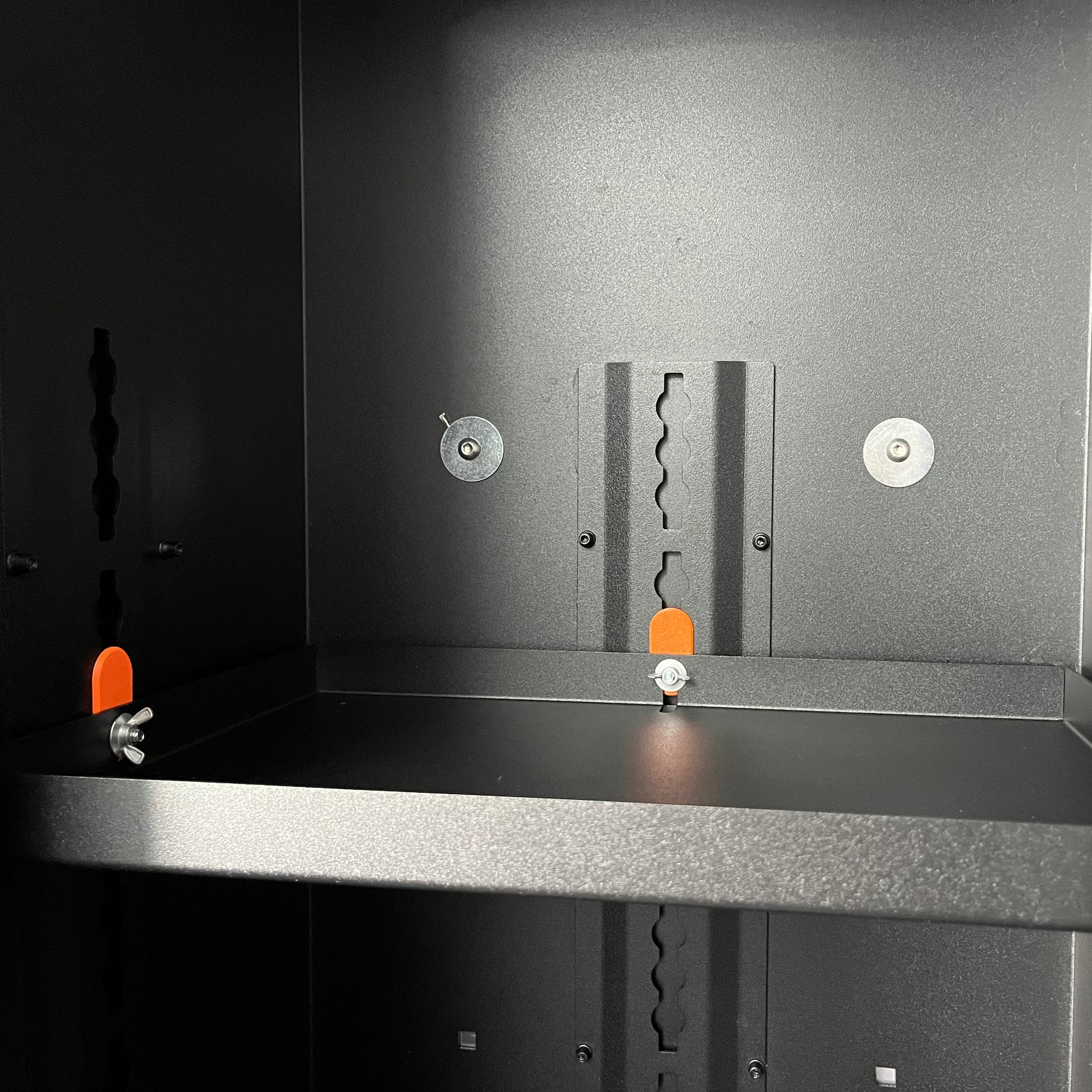 Avatar Additional Shelf for Storage Boxes add-on shelving inside a dark cabinet with orange pegs on Tampa Home & Garden Store
