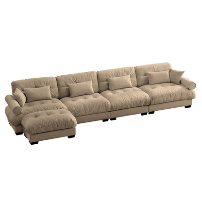 Modern sectional sofa with ottoman in tan fabric, rounded bolster arms, with many pillows on Tampa Home & Garden Store