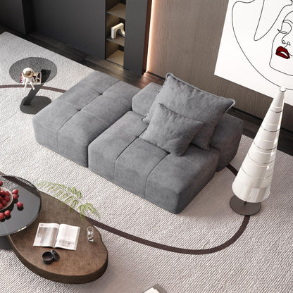 Modern oversized modular gray sectional sofa in a stylish living room with round glass coffee table on Tampa Home & Garden Store