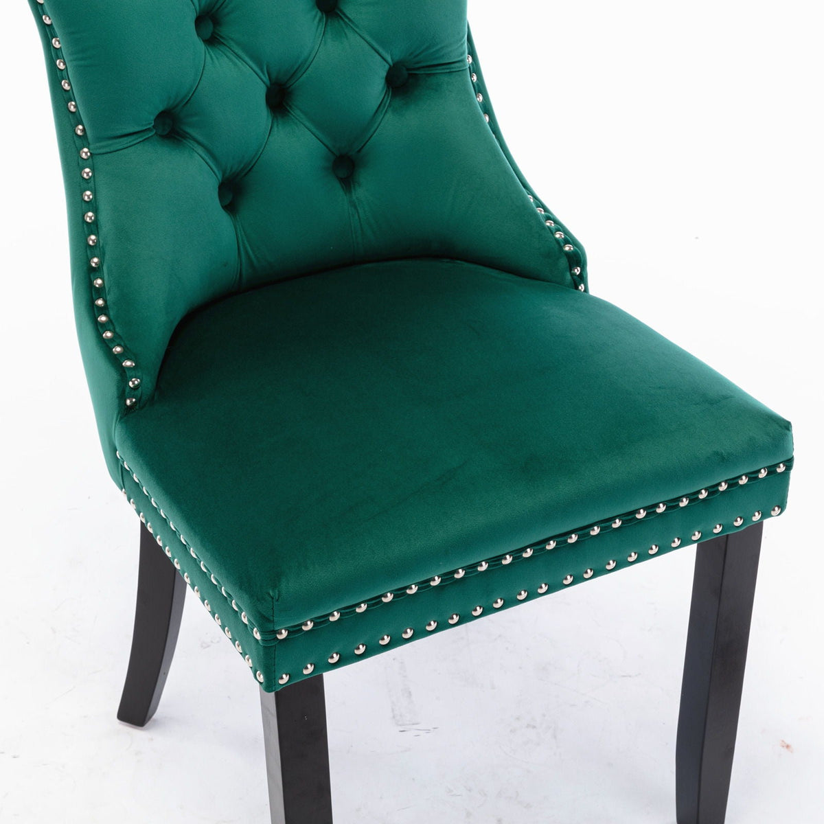 Tufted velvet dining chair in emerald green with nailhead trim and dark wood legs on Tampa Home & Garden Store