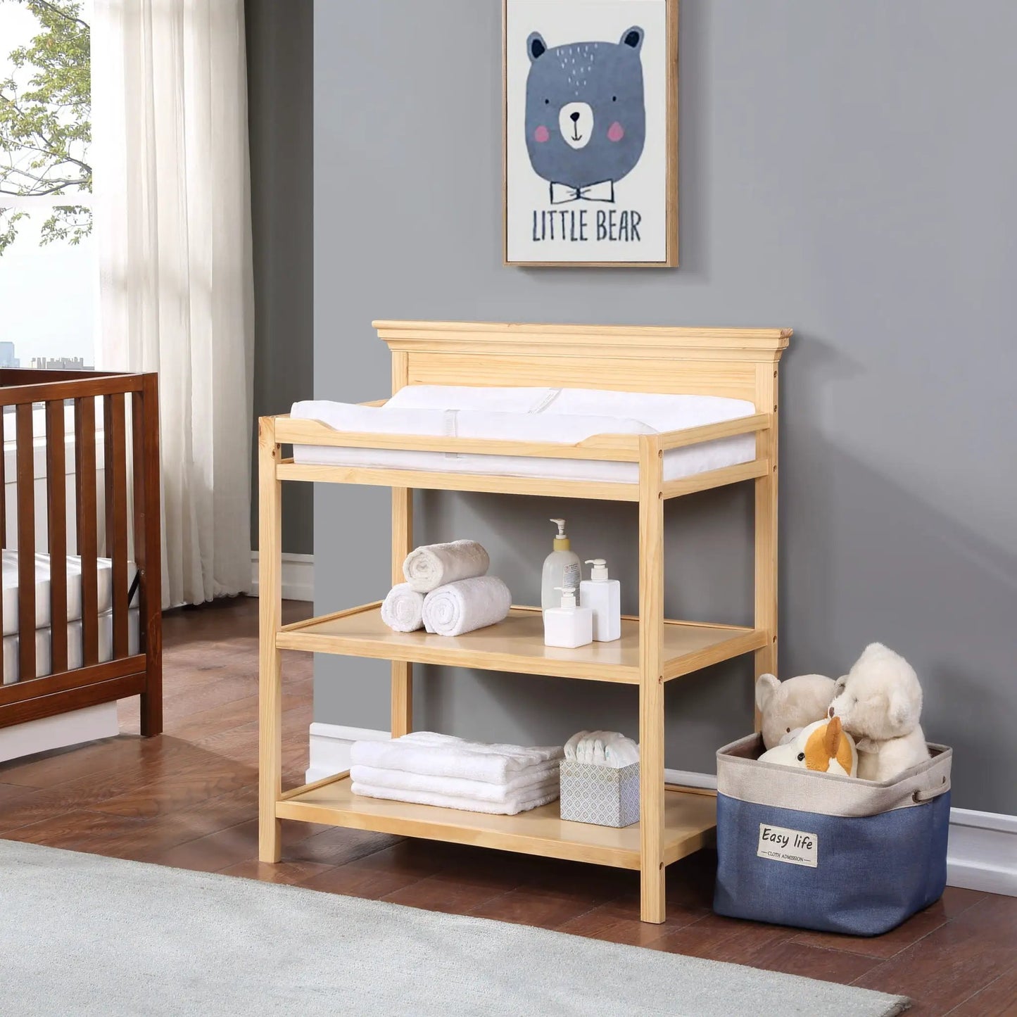 Universal Changing Table by Unique Piece Furniture in light wood with baby supplies on shelf on Tampa Home & Garden Store