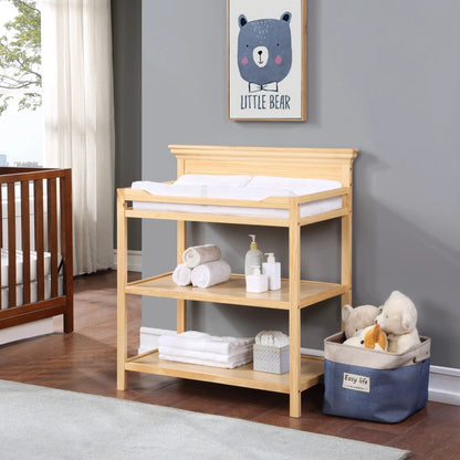 Universal Changing Table by Unique Piece Furniture in light wood with baby supplies on shelf on Tampa Home & Garden Store