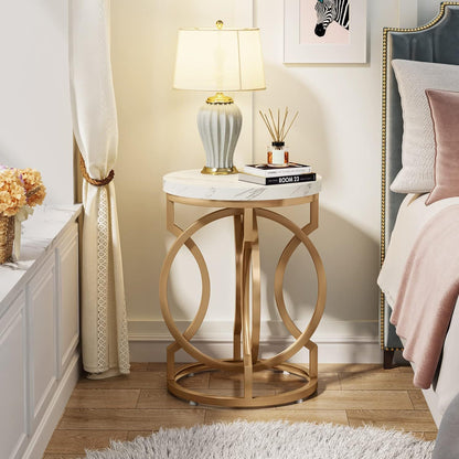 Round end table with O-shaped gold base and white marble top in a chic bedroom scene on Tampa Home & Garden Store