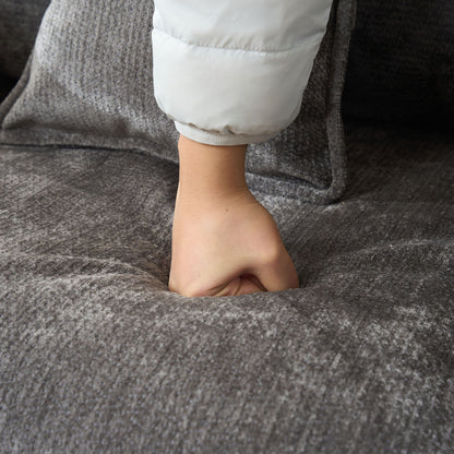 Modern Reading Armchair closeup: white puffer sleeve against gray textured upholstery on Tampa Home & Garden Store