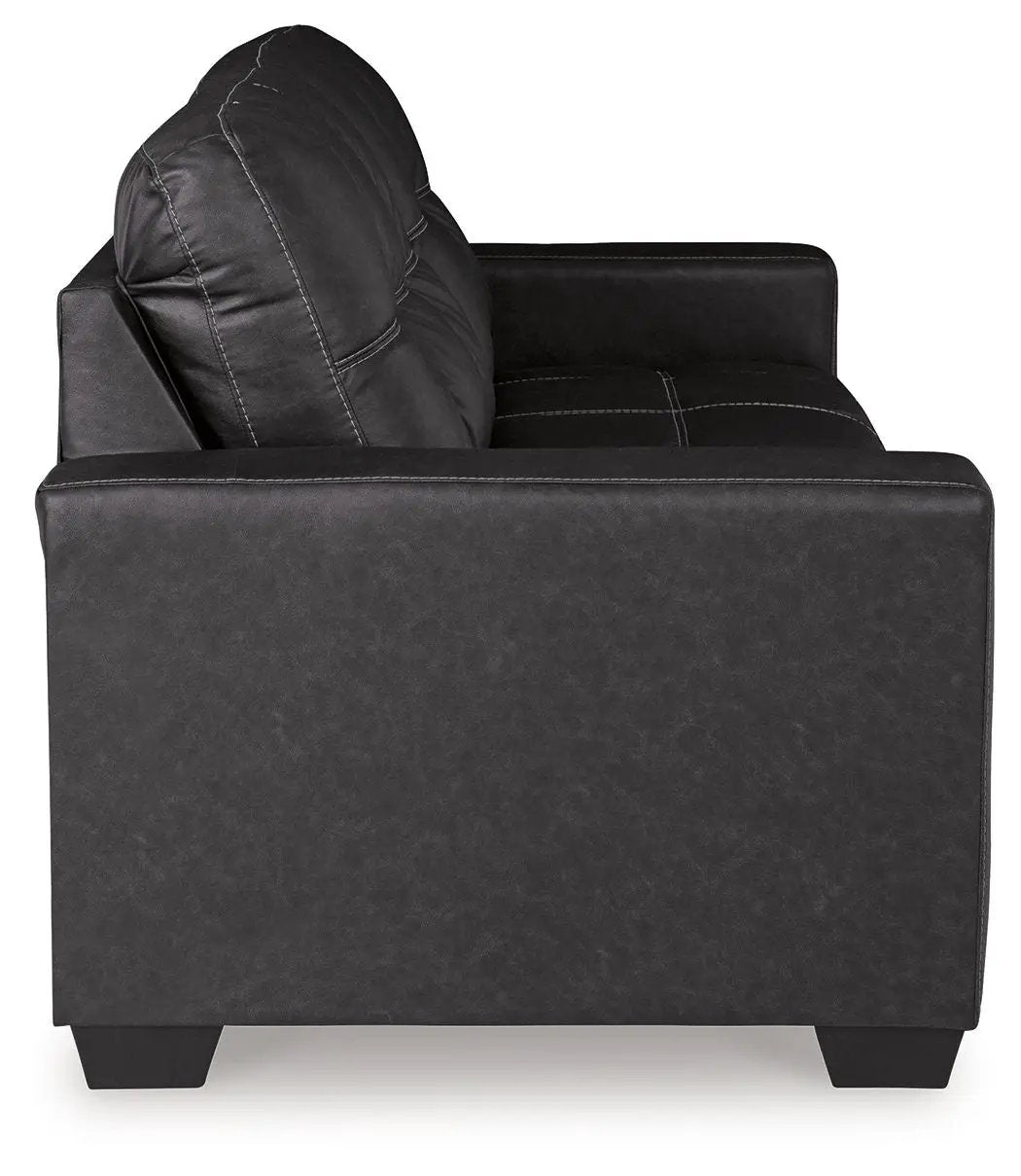 Barlin Mills Sofa Sleeper by Unique Piece Furniture in black faux leather with white contrast stitching on Tampa Home & Garden Store
