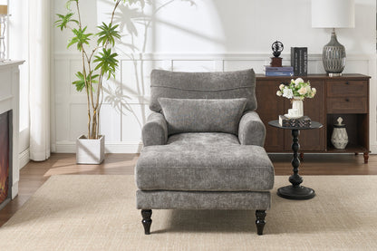 Modern grey upholstered chaise lounge sofa recliner in a living room beside a dark wood console on Tampa Home & Garden Store