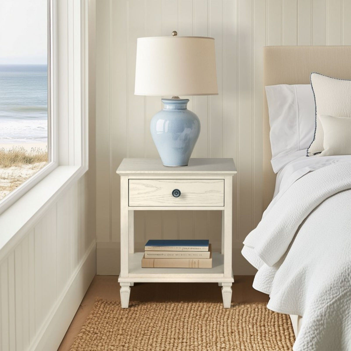 Bedside table with drawer and shelf in whitewashed solid wood with ceramic lamp in coastal bedroom on Tampa Home & Garden Store
