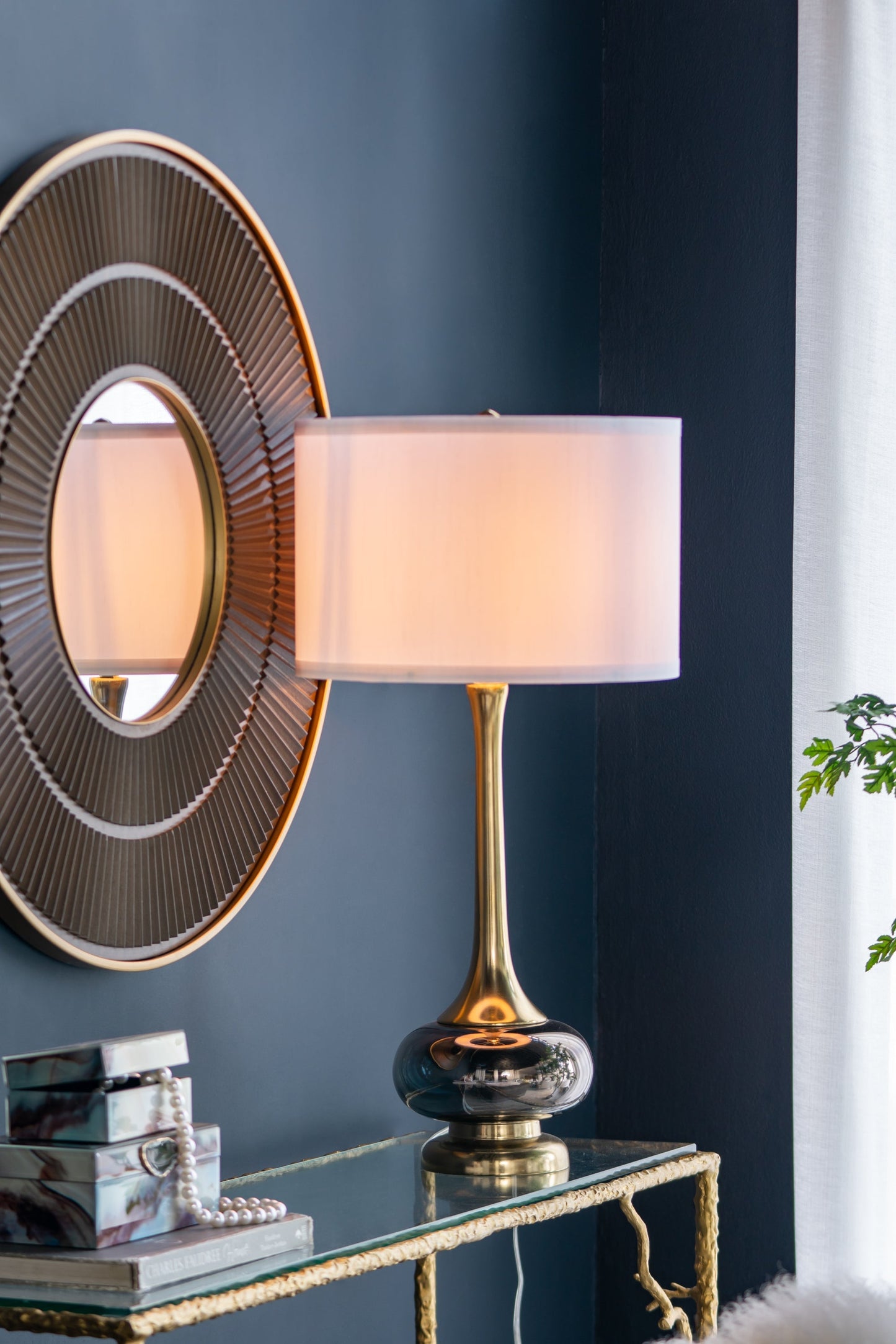 D15x29 table lamp with glass drum shade, brass stem, pale pink shade against blue wall on Tampa Home & Garden Store