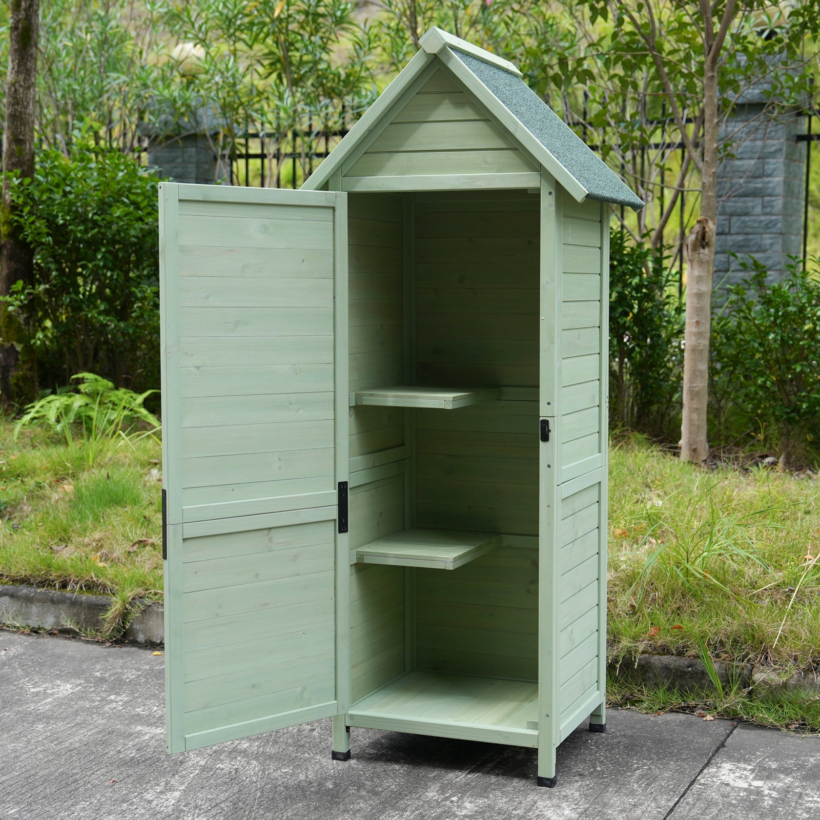 Outdoor wooden storage shed with lockable door, light green finish, interior shelves on Tampa Home & Garden Store