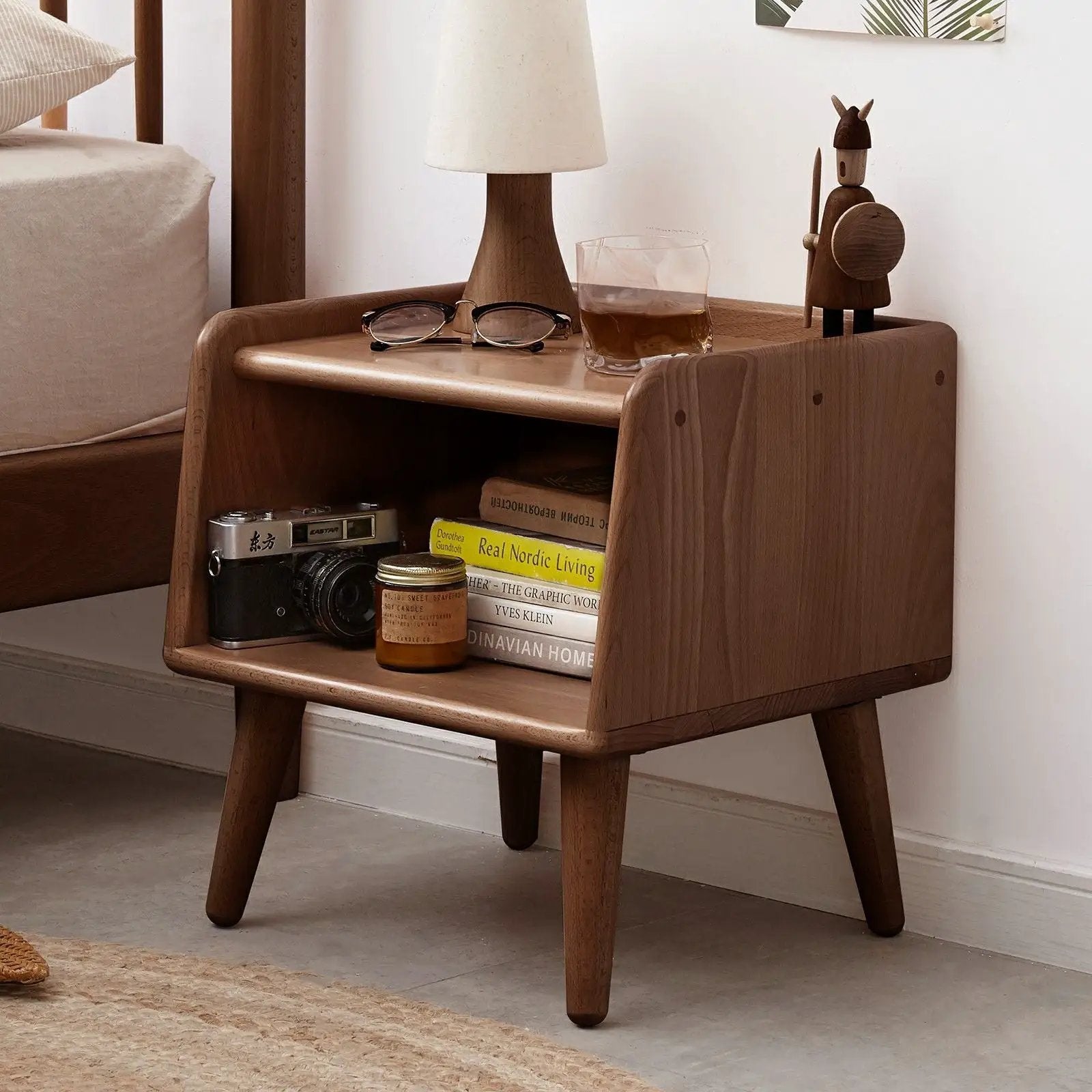 Bedside cabinet, modern beech nightstand with lamp, glasses, and wooden figurine on top on Tampa Home & Garden Store