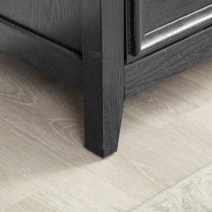 Modern 5-drawer black dresser closeup showing textured wood grain and drawer edge on Tampa Home & Garden Store