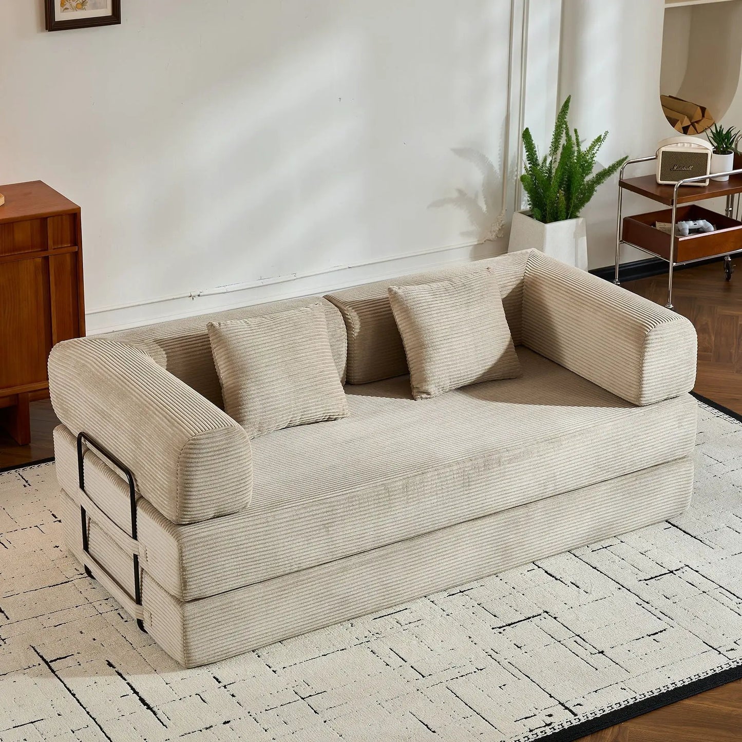 Convertible sleeper sofa bed with metal frame in beige ribbed fabric and cylindrical pillow on Tampa Home & Garden Store