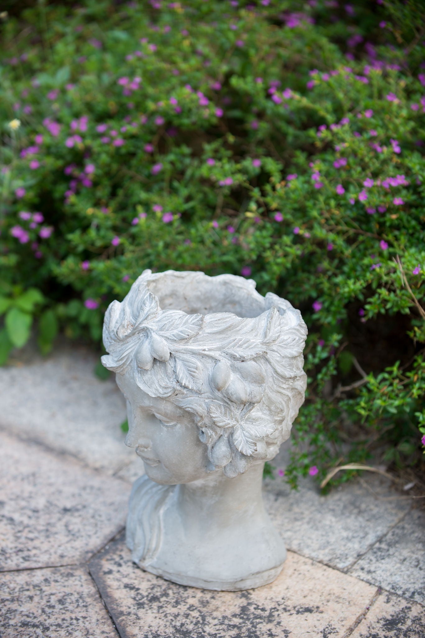 Gray cement bust wall planter with ornate leafy hair details for garden decor on Tampa Home & Garden Store