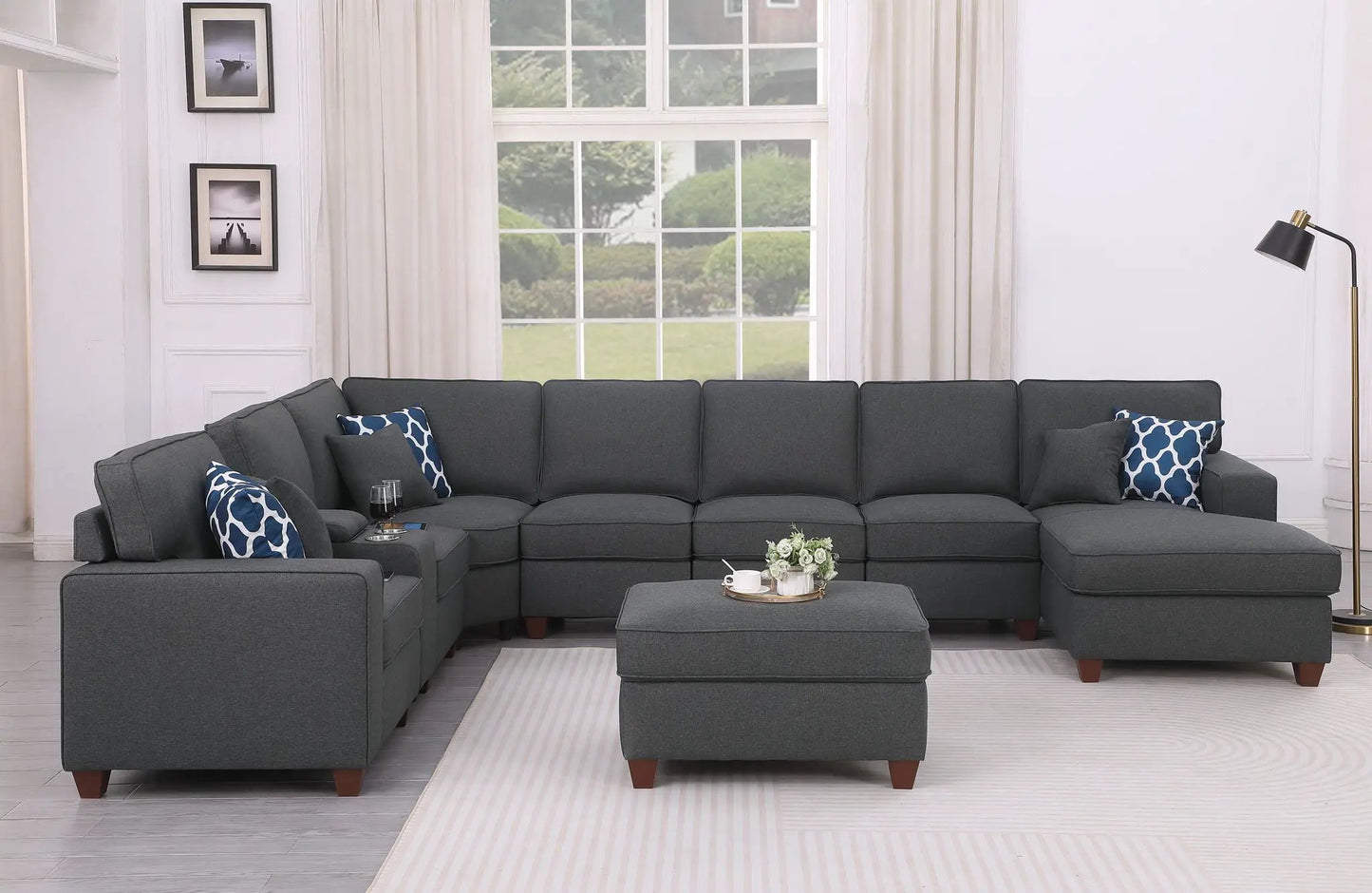 Eric - 9 Piece Upholstered Sectional With Ottoman in dark gray fabric with blue patterned pillows on Tampa Home & Garden Store