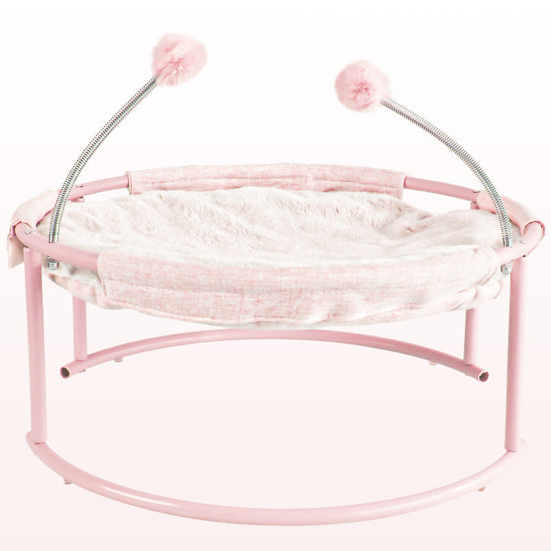 Cat bed hammock pink on curved pink stand with fluffy pom-pom toys by Sell My Stuff on Tampa Home & Garden Store