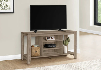 TV stand in light oak with flat-screen TV on top and open shelves featuring woven baskets on Tampa Home & Garden Store