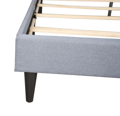 Button tufted bed upholstered in gray fabric with exposed wooden slats and black legs on Tampa Home & Garden Store