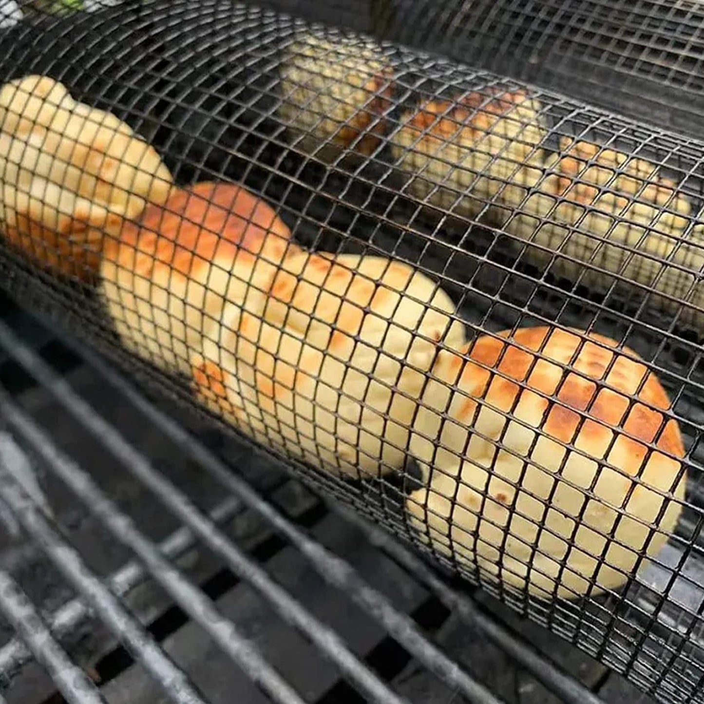Rolling grilling basket metal BBQ net by Perfecsy on grill with potatoes on Tampa Home & Garden Store