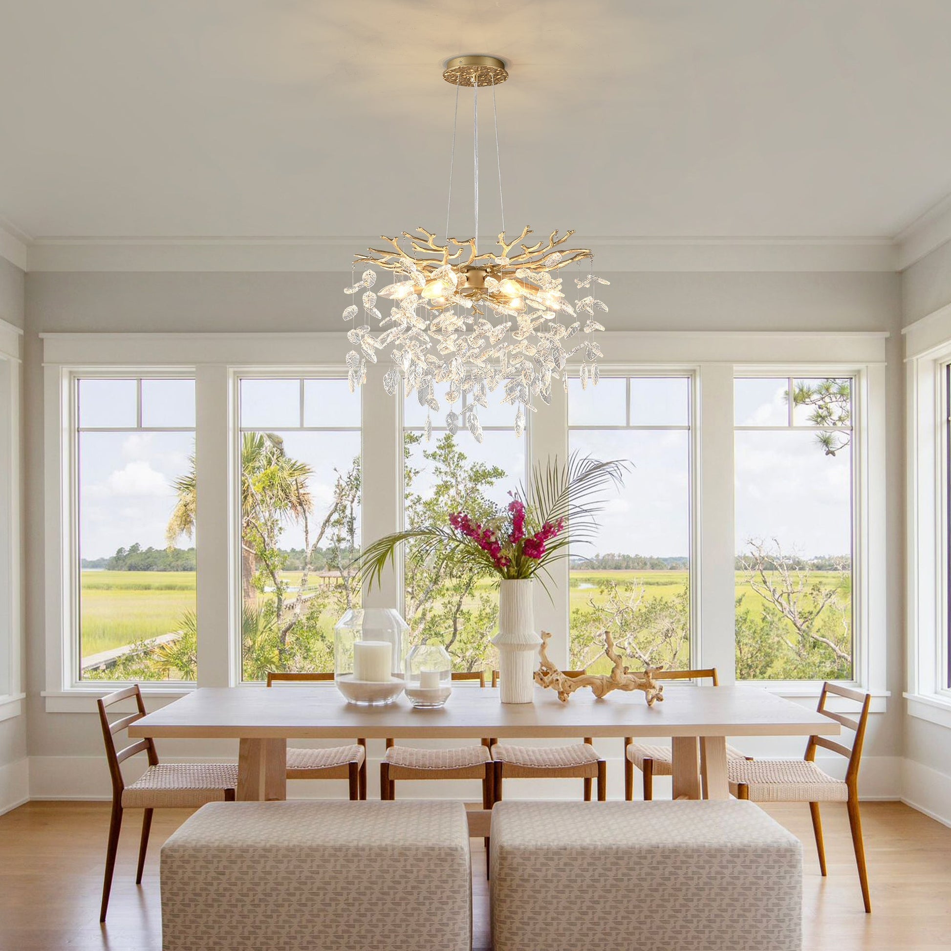 Gold-finish 6-light crystal chandelier with branch arms and crystal leaves over a dining table on Tampa Home & Garden Store