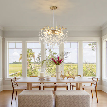 Gold-finish 6-light crystal chandelier with branch arms and crystal leaves over a dining table on Tampa Home & Garden Store