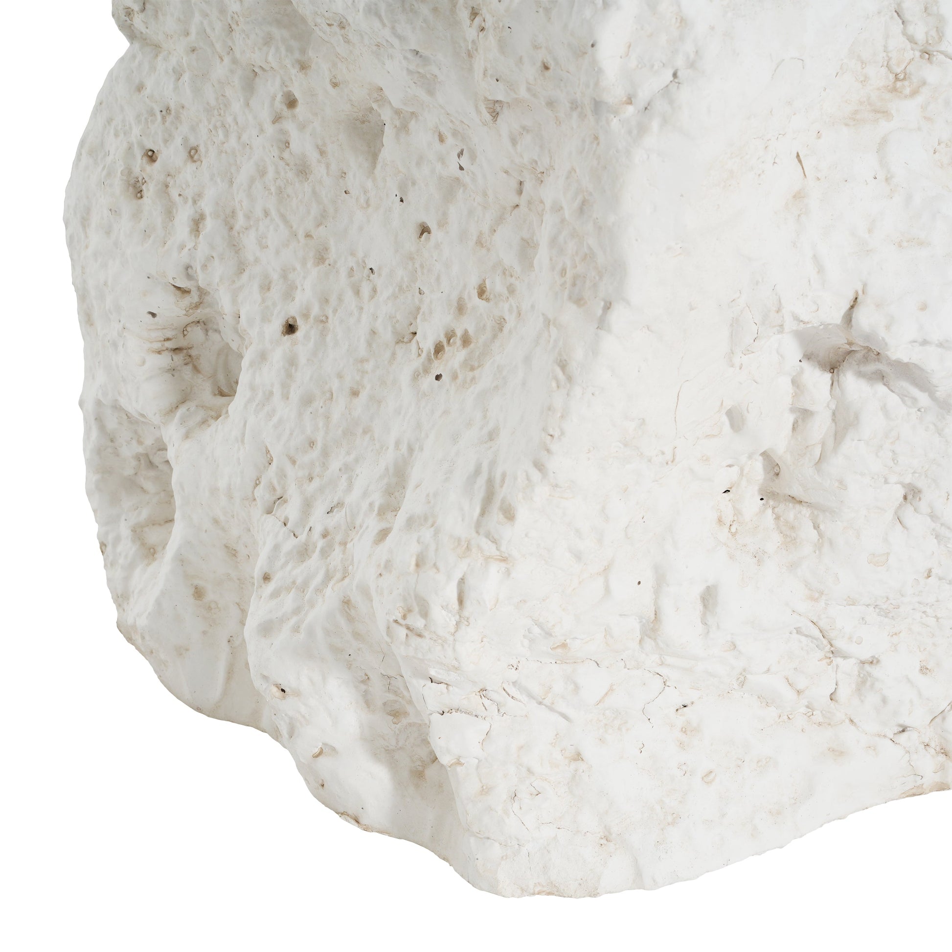 White textured rock surface with rough, pitted details and subtle beige specks on Tampa Home & Garden Store