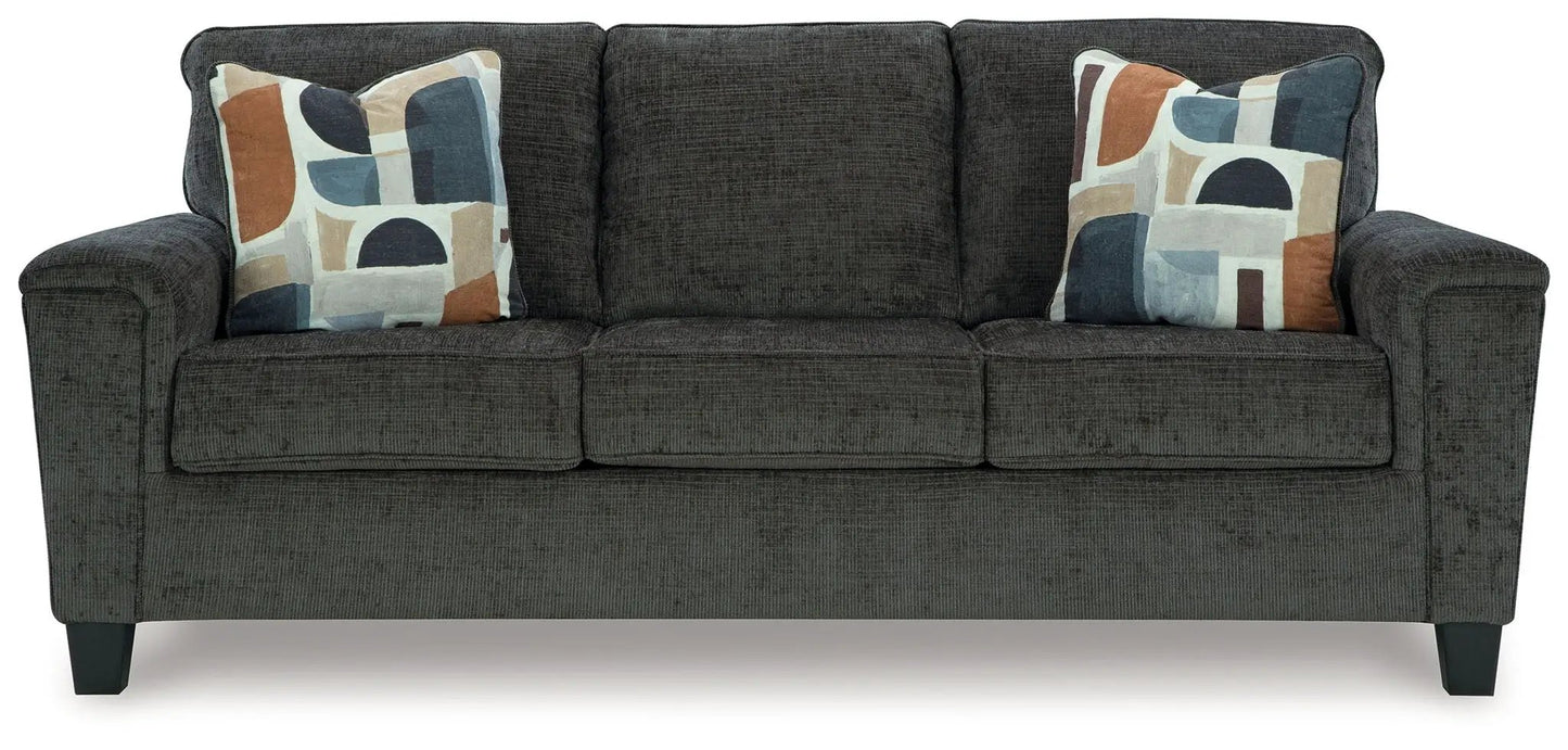 Erinslane stationary sofa in dark gray fabric with two abstract-pattern throw pillows on Tampa Home & Garden Store