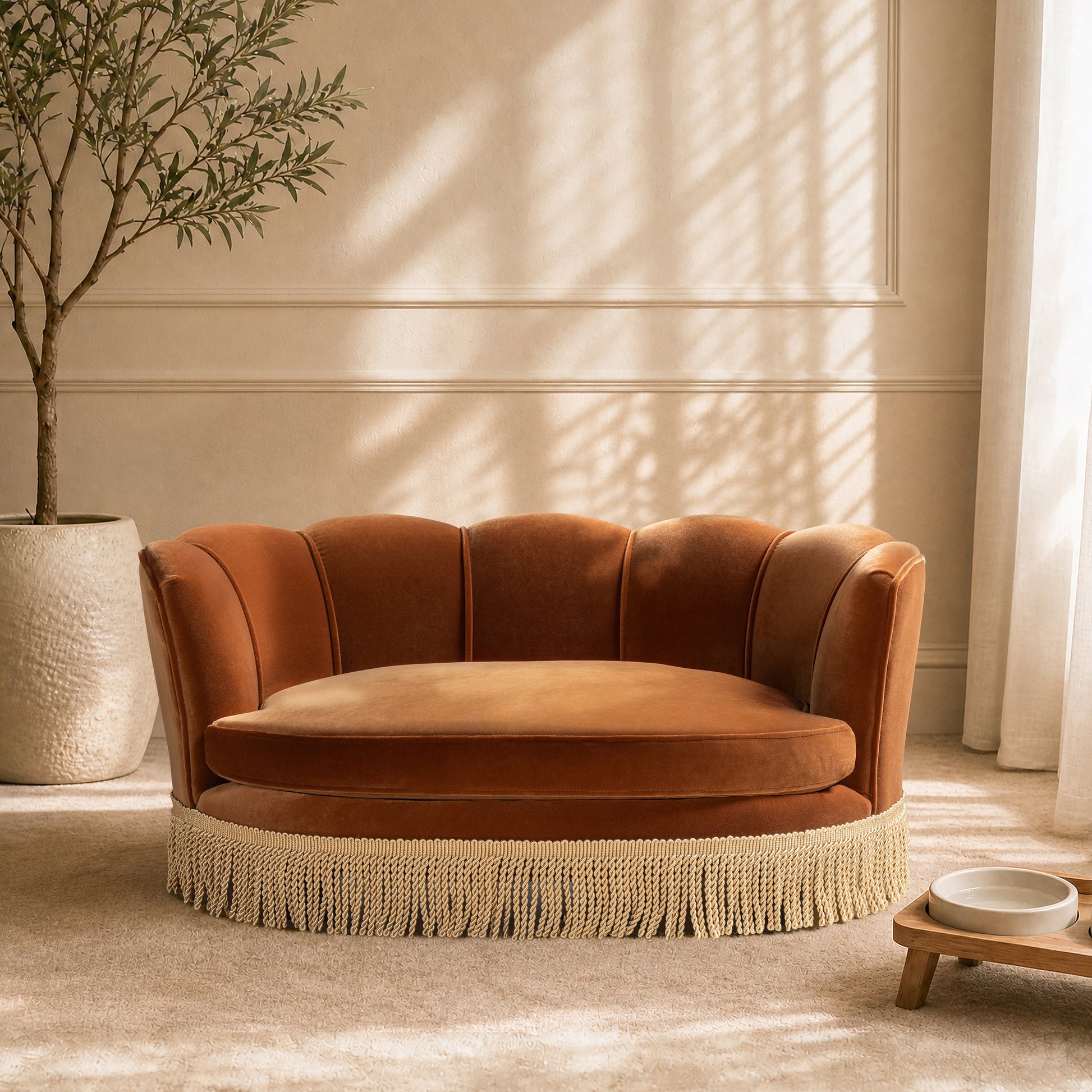 Clara 34.5in Scalloped Pet Sofa Bed medium burnt orange with fringe-trim base in a living room on Tampa Home & Garden Store