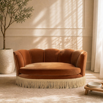 Clara 34.5in Scalloped Pet Sofa Bed medium burnt orange with fringe-trim base in a living room on Tampa Home & Garden Store