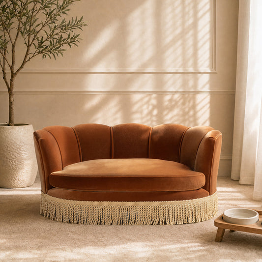 Clara 34.5in Scalloped Pet Sofa Bed medium burnt orange with fringe-trim base in a living room on Tampa Home & Garden Store