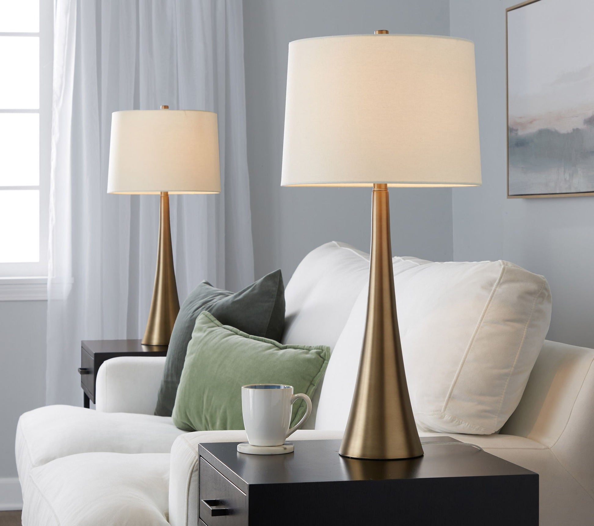 Diana contemporary table lamp set of 2 with brass bases and white shades in a modern living room on Tampa Home & Garden Store