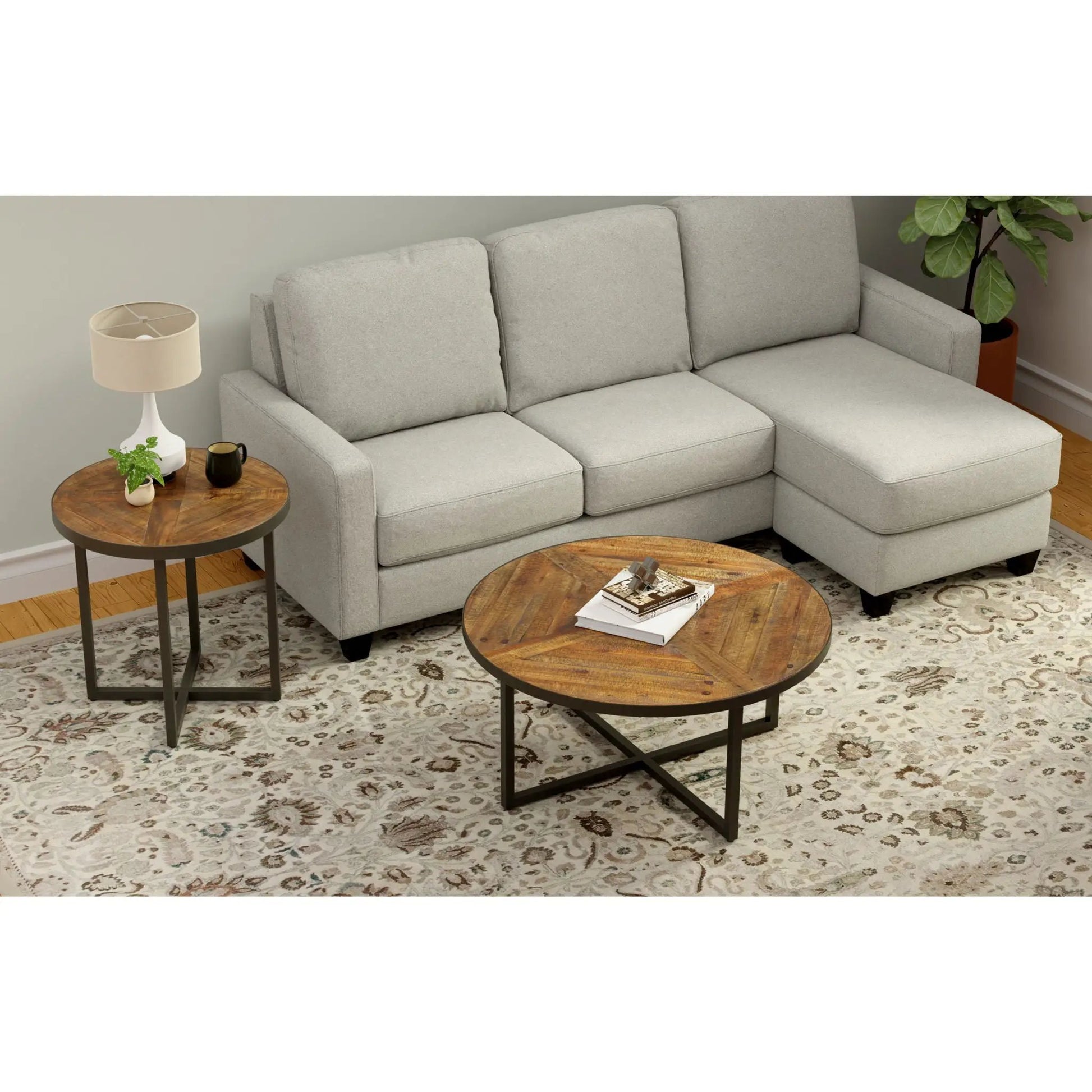 Faro round coffee tables, two wooden tops with black legs beside a gray sofa on Tampa Home & Garden Store