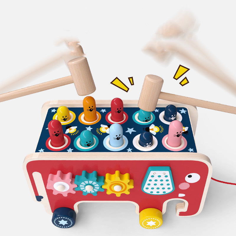 Wooden pounding bench bus with colorful animal pegs and side gears, two wooden hammers in action on Tampa Home & Garden Store