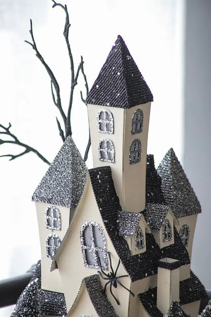 Cardboard lighted haunted house sculpture beige walls with glittery black roofs on Tampa Home & Garden Store