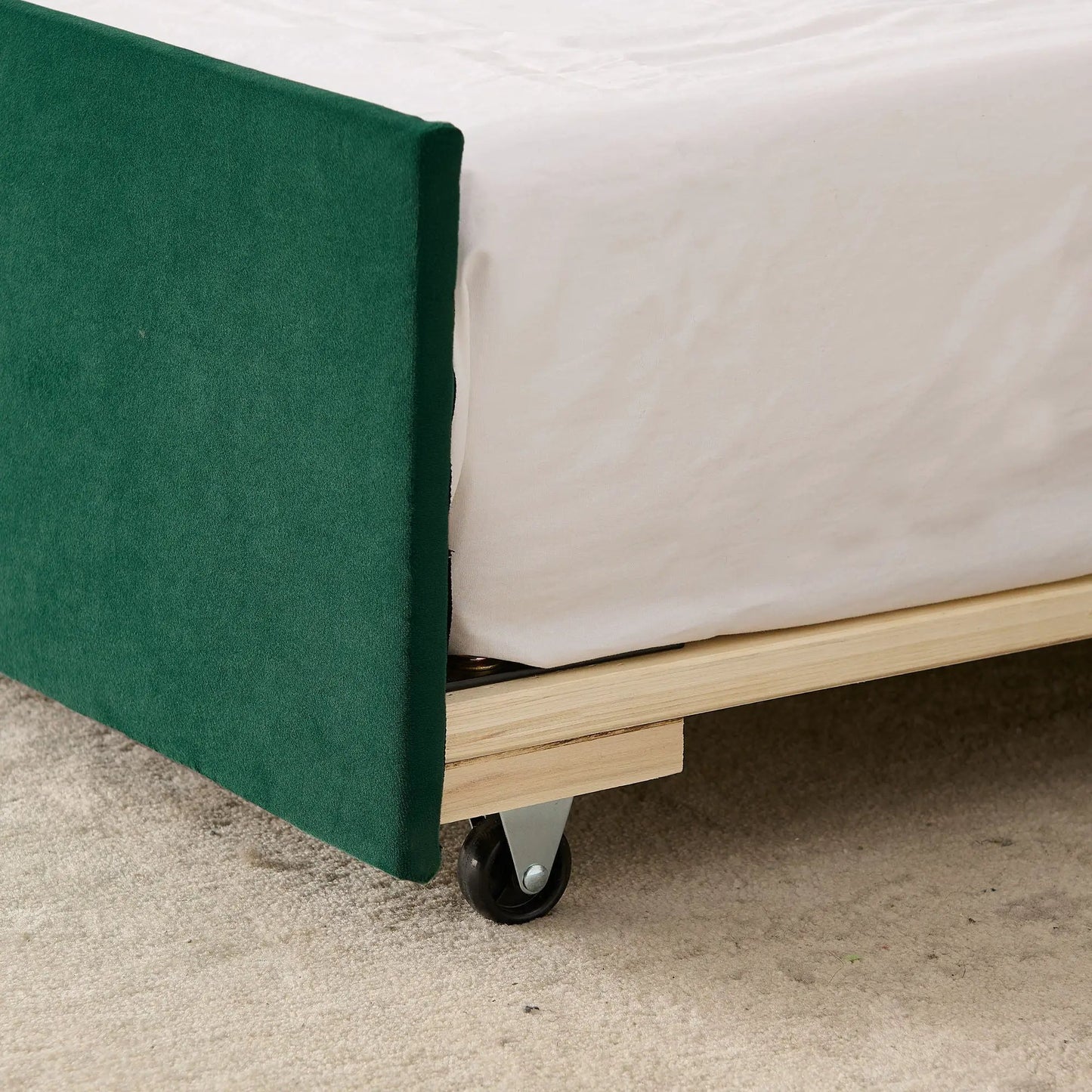 Daybed with pop-up trundle in emerald green upholstery over wood slat base with caster wheels on Tampa Home & Garden Store