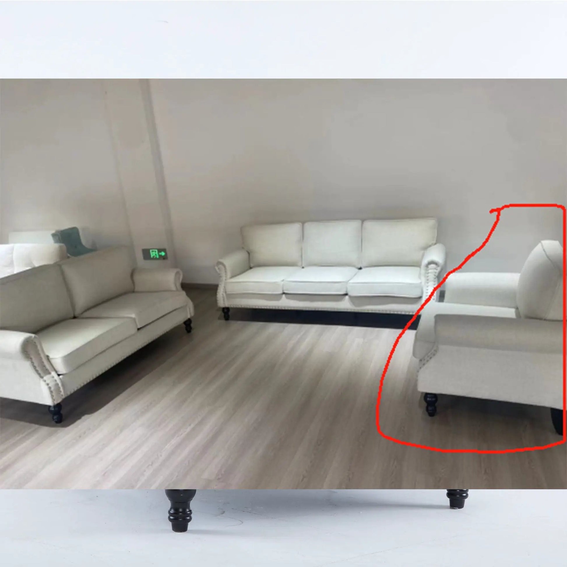 Rolled-arm cream sofa with nailhead trim, 1-seater on wooden legs in showroom on Tampa Home & Garden Store