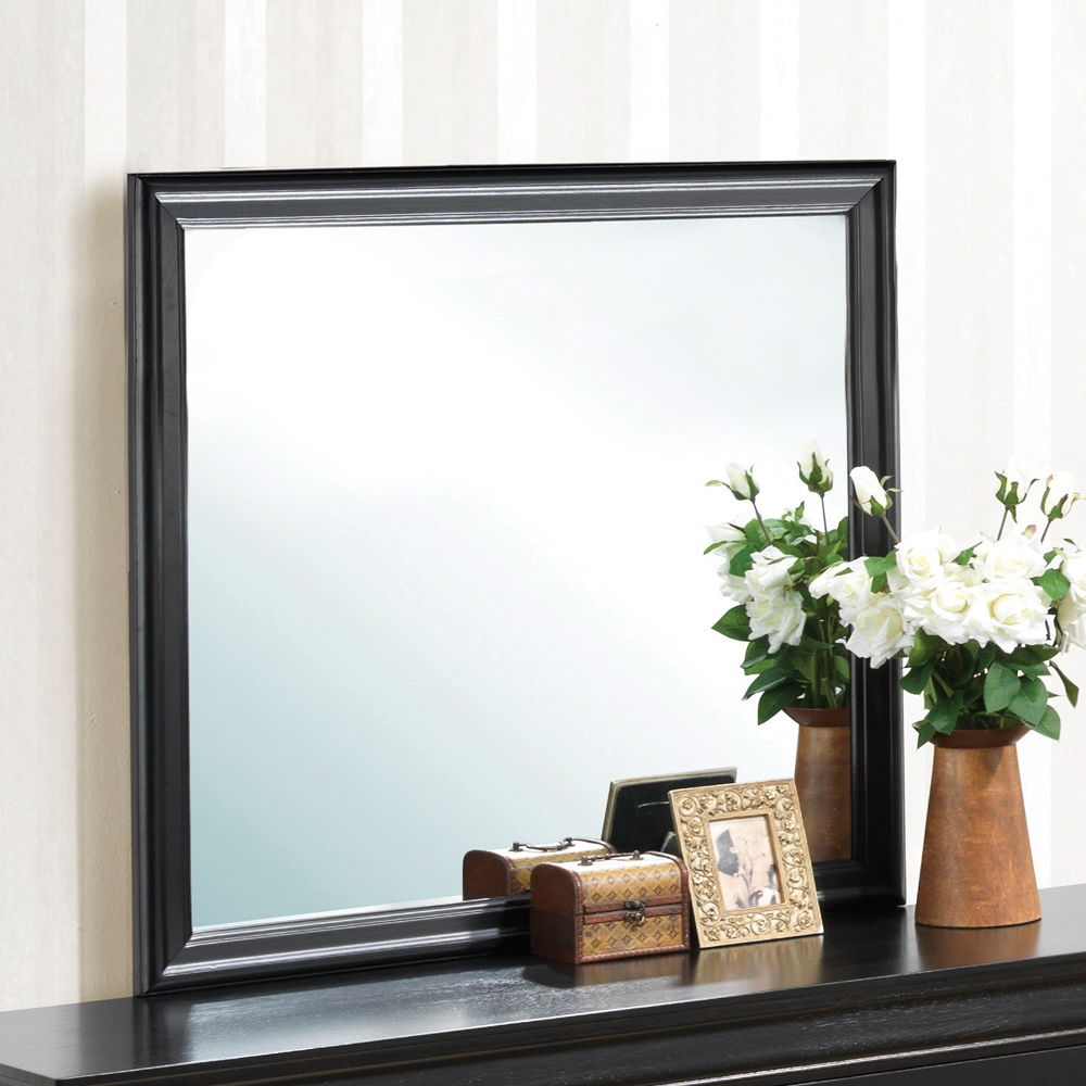 Elegant black wall mirror by HouseOfZazla with beveled frame on a console beside white roses on Tampa Home & Garden Store