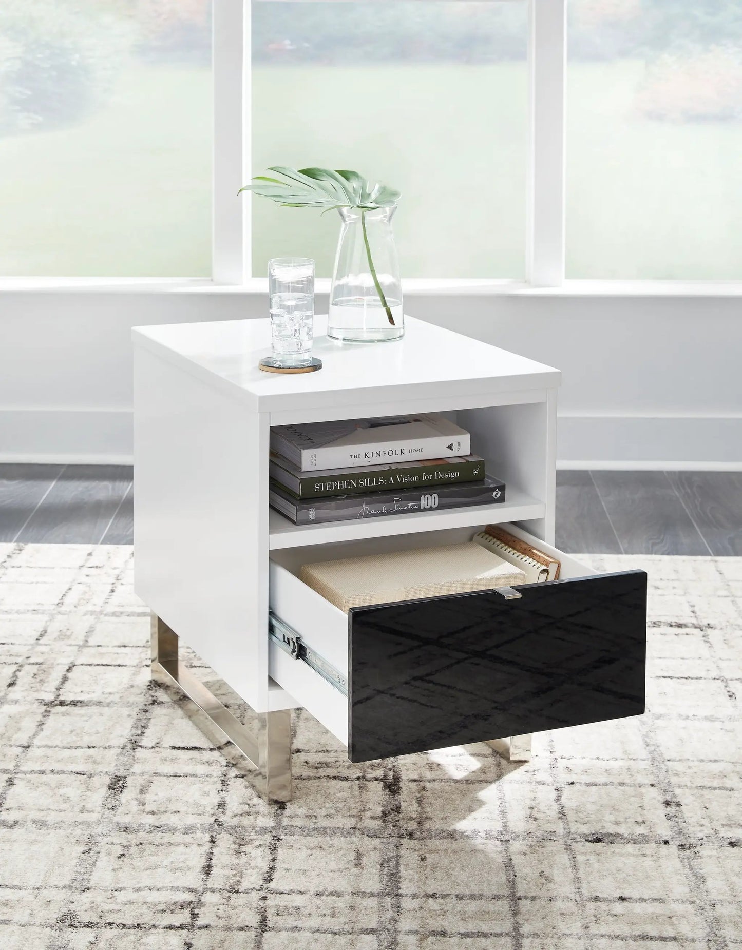 Gardoni chair side end table white top with black drawer, metal legs; vase and glass on top, magazines on shelf on Tampa Home & Garden Store