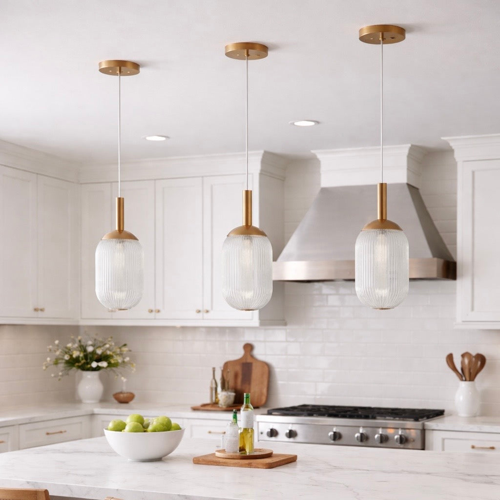 Modern Pendant Lamp with three pendant lamps, bronze hardware and glass shades over white island on Tampa Home & Garden Store