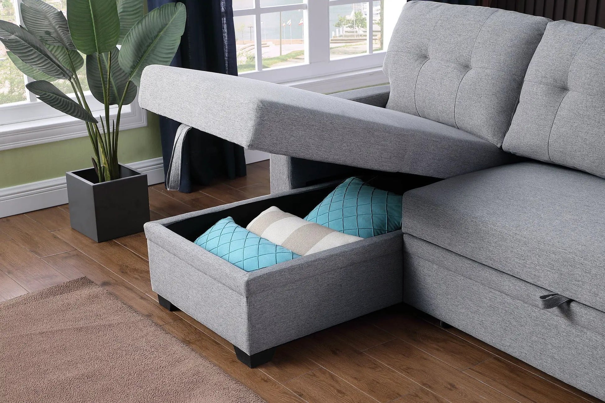 Upholstered sleeper sectional sofa with chaise in gray fabric, storage with blue cushions on Tampa Home & Garden Store