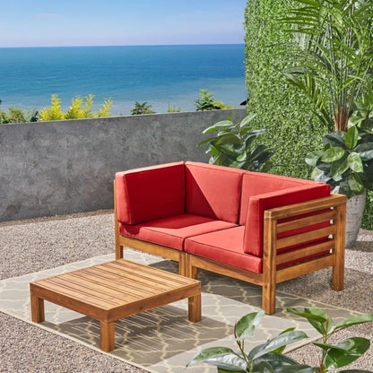 Oana 3-piece outdoor loveseat set with coffee table in acacia wood and red cushions on Tampa Home & Garden Store