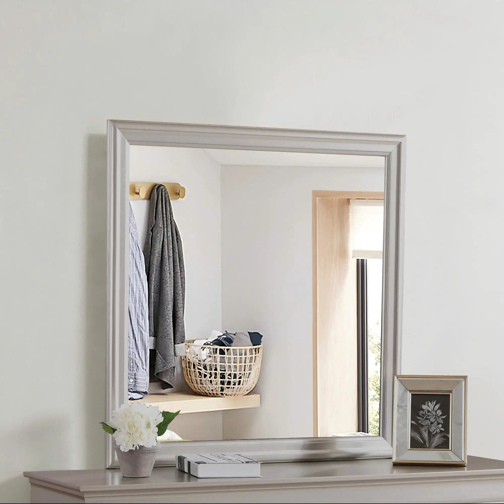 Traditional wall mirror with a silver beveled frame mounted on a light gray wall on Tampa Home & Garden Store