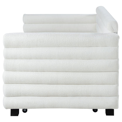 White bath towel set stacked neatly with one rolled towel on top; black metal legs visible on Tampa Home & Garden Store