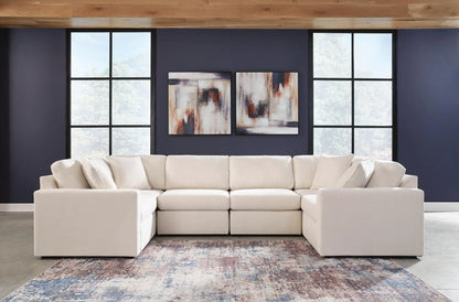 Modmax Sectional Oyster beige fabric stationary sofa with plush cushions against a navy wall on Tampa Home & Garden Store