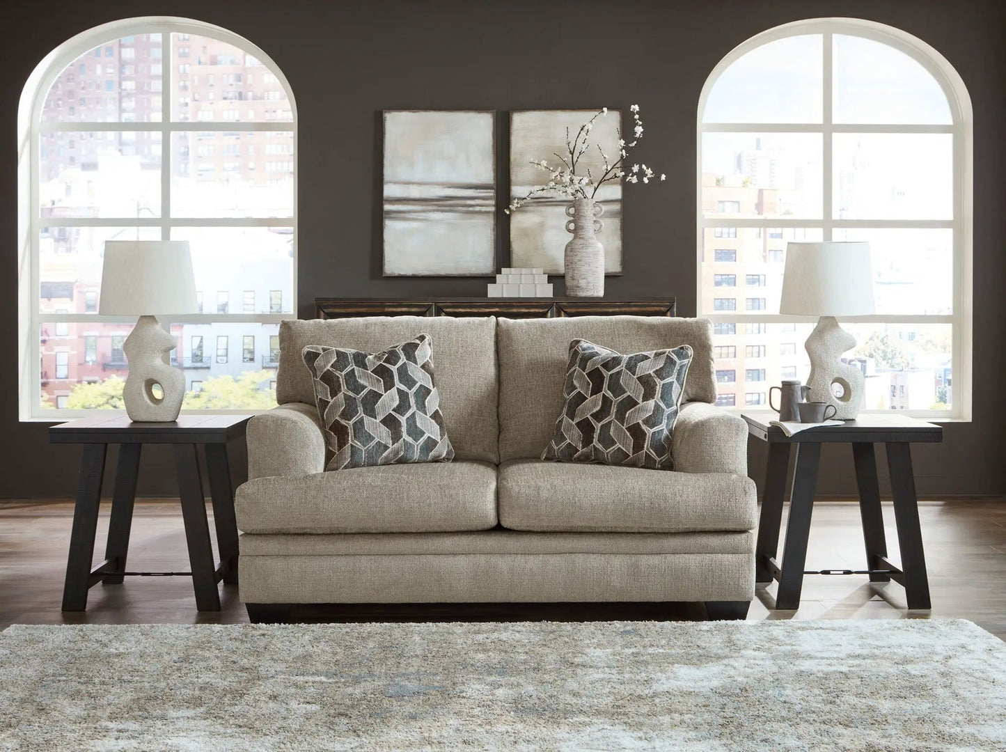Stonemeade 3-piece living room set beige sofa with black end tables and lamps on dark wall on Tampa Home & Garden Store