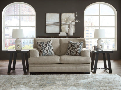 Stonemeade 3-piece living room set beige sofa with black end tables and lamps on dark wall on Tampa Home & Garden Store